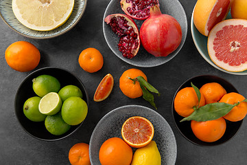 Image showing close up of citrus in bowls fruits on stone table