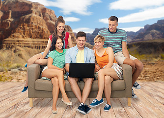 Image showing friends with laptop over grand canyon