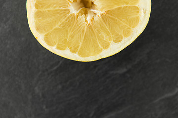 Image showing close up of lemon slice on slate table top