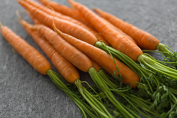 Image showing close up of carrot bunch on table