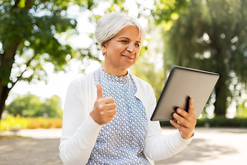 Image showing senior woman with tablet pc showing thumbs up