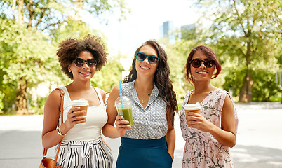 Image showing happy women or friends with drinks at summer park