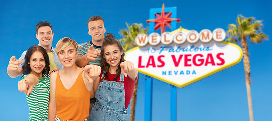 Image showing friends pointing at you over las vegas sign