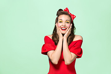 Image showing Beautiful young woman with pinup make-up and hairstyle. Studio shot on white background