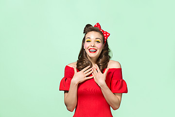 Image showing Beautiful young woman with pinup make-up and hairstyle. Studio shot on white background