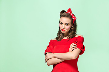 Image showing Beautiful young woman with pinup make-up and hairstyle. Studio shot on white background