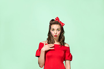 Image showing Beautiful young woman with pinup make-up and hairstyle. Studio shot on white background