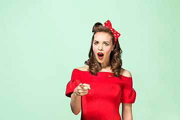 Image showing Beautiful young woman with pinup make-up and hairstyle. Studio shot on white background