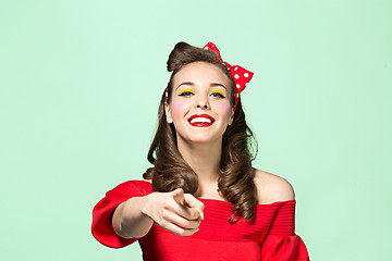 Image showing Beautiful young woman with pinup make-up and hairstyle. Studio shot on white background