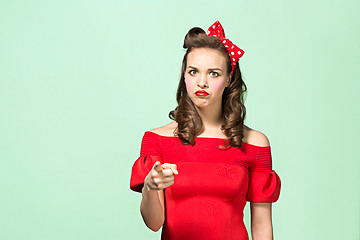 Image showing Beautiful young woman with pinup make-up and hairstyle. Studio shot on white background