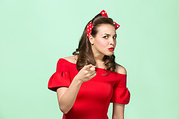 Image showing Beautiful young woman with pinup make-up and hairstyle. Studio shot on white background