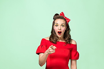 Image showing Beautiful young woman with pinup make-up and hairstyle. Studio shot on white background