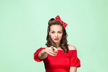 Image showing Beautiful young woman with pinup make-up and hairstyle. Studio shot on white background