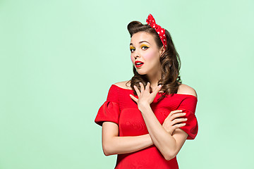 Image showing Beautiful young woman with pinup make-up and hairstyle. Studio shot on white background