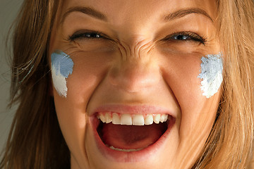 Image showing Portrait of a woman with the flag of the Argentina painted on her face.