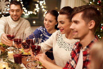 Image showing friends celebrating christmas and drinking wine