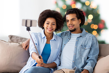 Image showing couple with smartphone taking selfie on christmas