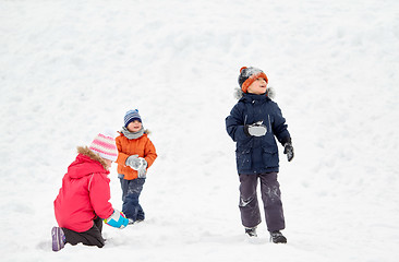 Image showing happy little kids playing outdoors in winter