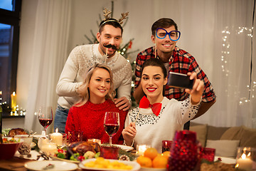 Image showing friends taking selfie at christmas dinner