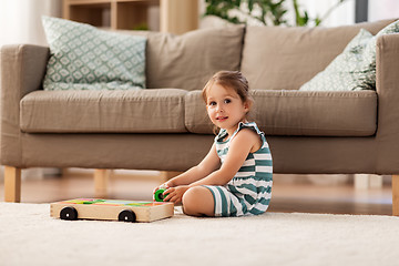 Image showing happy baby girl playing with toy blocks at home