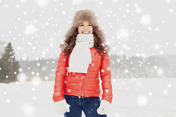 Image showing happy woman in winter fur hat outdoors