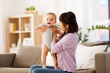 Image showing happy young asian mother with little baby at home