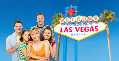 Image showing happy friends over las vegas sign background