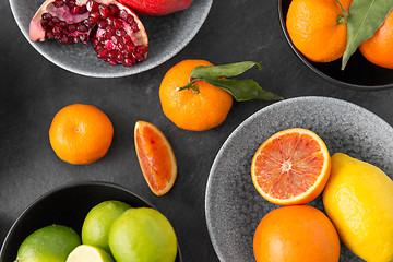 Image showing close up of citrus in bowls fruits on stone table