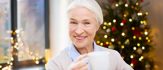 Image showing happy senior woman with cup of coffee