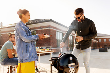 Image showing friends cooking meat on bbq at rooftop party