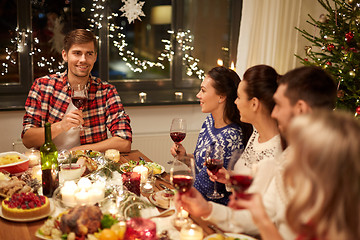 Image showing friends celebrating christmas and speaking toast