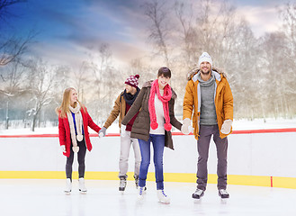 Image showing happy friends on outdoor skating rink