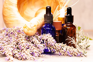 Image showing lavender mortar and pestle and bottles of essential oils for aro