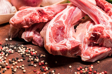 Image showing raw lamb chops on a wooden board for barbecue