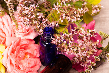 Image showing flowers and bottles of essential oils for aromatherapy