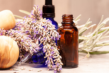 Image showing lavender mortar and pestle and bottles of essential oils for aro