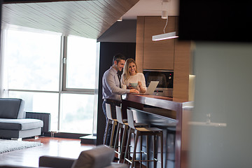 Image showing A young couple is preparing for a job and using a laptop