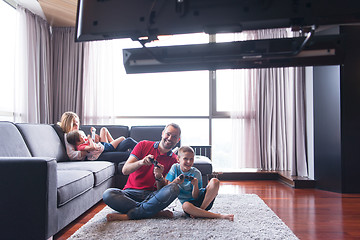 Image showing Happy family playing a video game