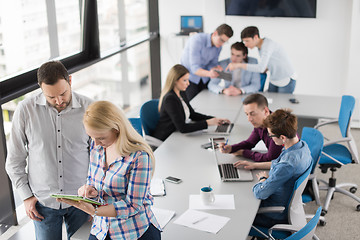 Image showing Two Business People Working With Tablet in office