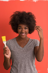 Image showing black woman painting wall