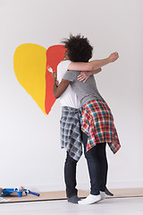 Image showing couple with painted heart on wall