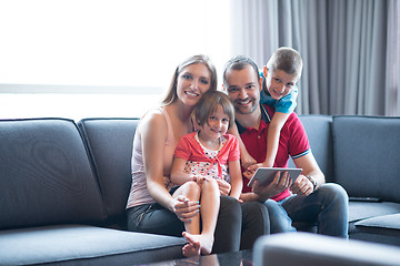 Image showing happy young couple spending time with kids