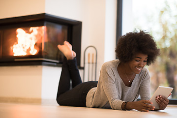 Image showing black women using tablet computer on the floor