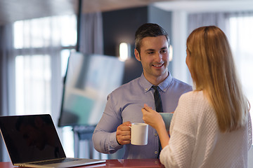 Image showing A young couple is preparing for a job and using a laptop