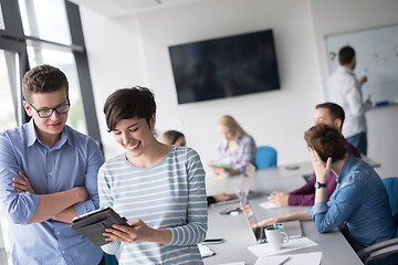 Image showing Two Business People Working With Tablet in office