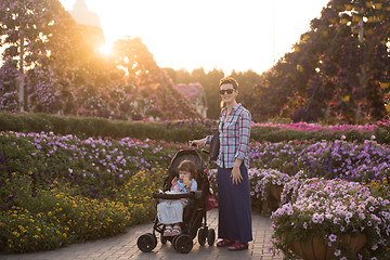 Image showing mother and daughter in flower garden