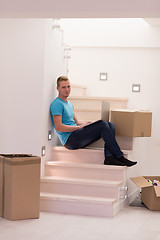 Image showing young man sitting in stairway at home