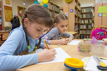 Image showing Schoolgirls in extracurricular activities draw in the library