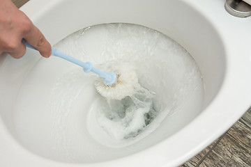 Image showing Flush water after cleaning the toilet brush
