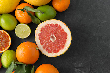 Image showing close up of citrus fruits on stone table